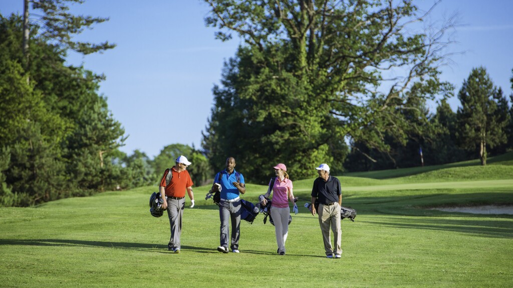 Golfers walking on golf course 