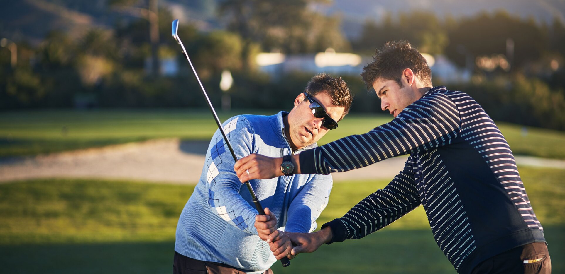 Golfer receiving instruction on golf course
