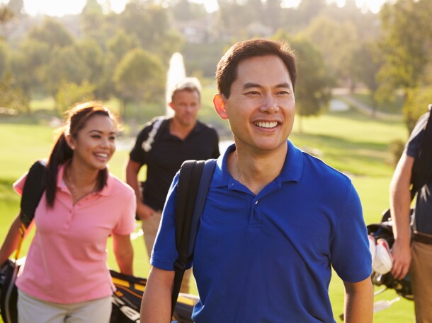 Golfers walking on golf course